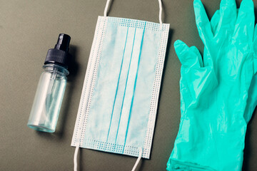 Close up photo of medicinal mask and gloves and hand sanitizer.