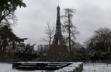 The black and white Eiffel tower with bare trees in winter, Paris, France.