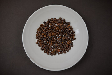 roasted coffee beans on a white plate