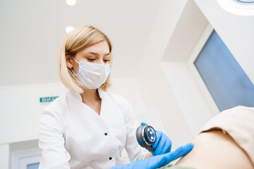 Dermatologist makes an examination using a dermatoscope. Consultation with a doctor. Rejuvenating...