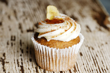 cupcake with icing on wood background