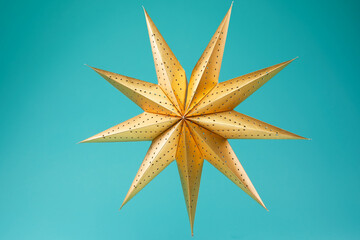 Eight pointed gold star isolated on blue background