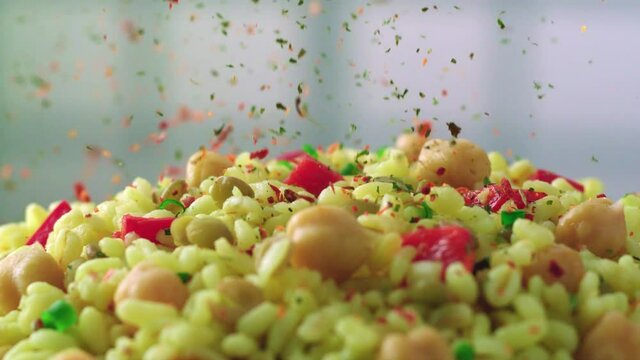 Delicious bulgur pilaf with vegetables and chickpeas. Spices are thrown on it. Turkish food video.