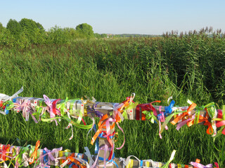 Fototapeta premium Russia, Pereslavl-Zalessky, Pleshcheyevo lake. People come here to make a wish. They tie ribbons for good luck. They dream of love.