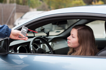 drink and drive crashed young female driver being subject to test for alcohol content with use of...