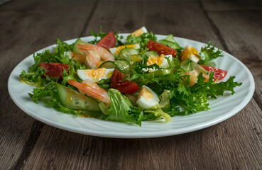 Green salad with shrimps, quail eggs, cucumber and tomato. Healthy breakfast with herbs, shrimps and eggs