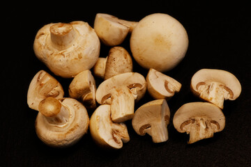 whole white button mushrooms, or agaricus isolated on a black background