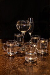 Dishes, on a wooden table, various glass glasses with drinks