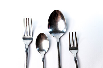 Two forks and two spoons, isolated on white