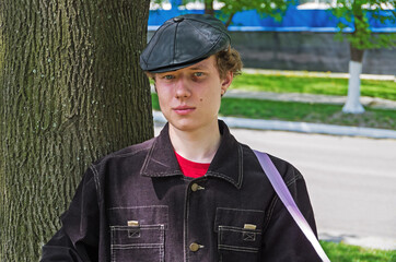 Indigenous hooligan from poor areas in leather black cap