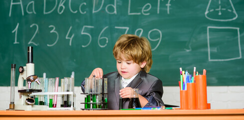 little boy at lesson. Back to school. Biology school laboratory equipment. school kid scientist studying science. Little boy at the elementary school. Little kid Studying hard