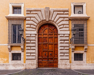 vintage building entrance arched natural wood door, Rome Italy