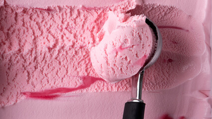 Ice cream Strawberry scooped out from container with a spoon, Closeup Top view Food concept..