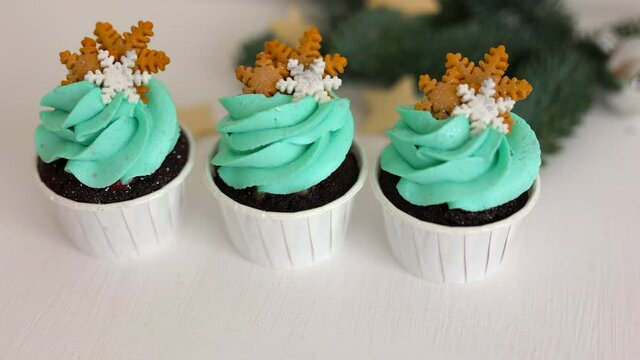 
cupcakes with tiffany cream and snowflakes on a white table