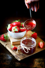 Selective focus. Close-up. Strawberry jam and fresh strawberries. Cooking strawberry jam.