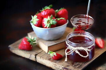 Selective focus. Close-up. Strawberry jam and fresh strawberries. Cooking strawberry jam.