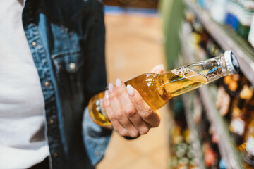 Close-up of female hand holding glass bottle
