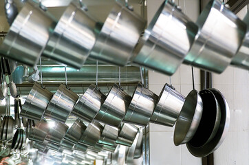 Stainless steel kitchen utensil rack, hanging kitchen utensil set, pans and saucepans in modern...