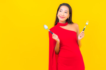 Portrait beautiful young asian woman with spoon and fork ready to eat