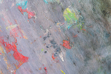 colorful creative motley background: smudged residues of oil paints on a wooden palette, short...