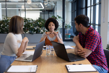 Diverse group of business people working in creative office