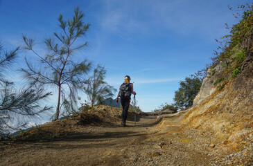 A woman walking down from the top of mount Ijen Banyuwangi Indonesia