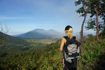 Fototapeta na wymiar A woman walking down from the top of mount Ijen Banyuwangi Indonesia