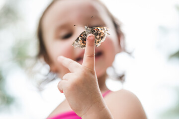 child holding butterfly