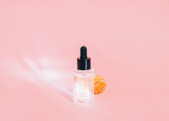 Skincare gel Photo with copy space in minimal style Transparent gel in glass bottle and tangerine...
