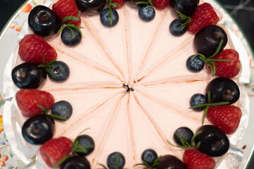 Cake cream rose decoration with raspberries and berries