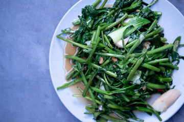 Stir fried morning glory with garlic and fresh peppers.