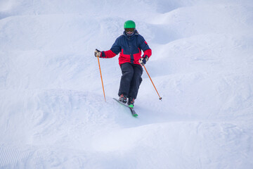 Fototapeta na wymiar People are enjoying mogul skiing and snow boarding 