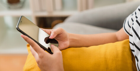 Woman holding a smartphone and using social media on internet.