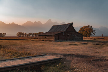 old barn at sunset and teton mountains 