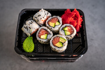Japanese food delivery. Rolls with salmon and avocado in box
