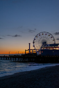 Ferris wheel at sunset on pier silhouette 