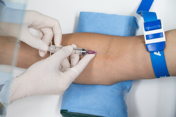 Close up nurse hand collecting blood sample for diagnosis covid-19, Coronavirus.Laboratory technician taking blood for blood chemistry diagnosis by automatic machine.