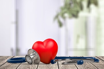 Medical stethoscope with a red heart on desk