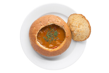 A traditional dish of Russian cuisine Goulash soup in bread. Restaurant serving concept. Close-up.