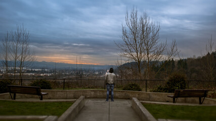 jogging in the park in spring standing overlooking mountain freeway urban park moody