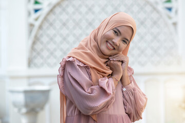 Portrait of islamic woman, Muslim woman wearing hijab smiling and looking at camera at outdoor