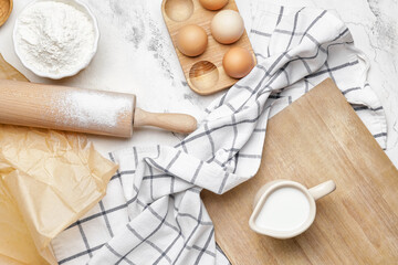 Ingredients for dough and rolling pin on light background