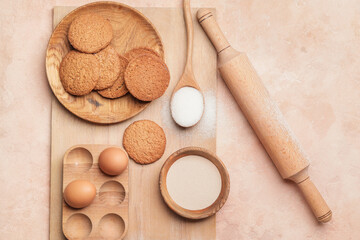Ingredients for cookies and rolling pin on color background