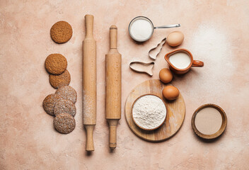 Fototapeta na wymiar Ingredients for cookies and rolling pins on color background