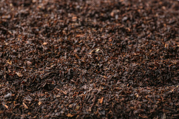 Dry black tea leaves as background
