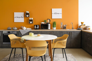 Interior of modern kitchen with dining table