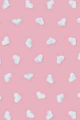 Valentines Day pattern with white hearts on pink colored. Greeting card or invitation for wedding cards. Pastel colors.