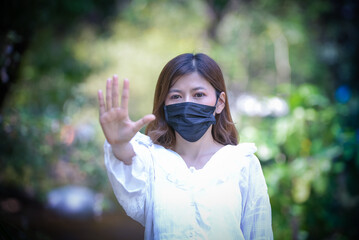 Asian women wearing sanitary masks for safety from the Covid 19 virus is spreading around the world.