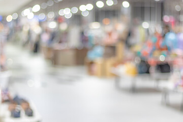 Abstract blurred supermarket aisle with colorful shelves and unrecognizable customers as background - obrazy, fototapety, plakaty