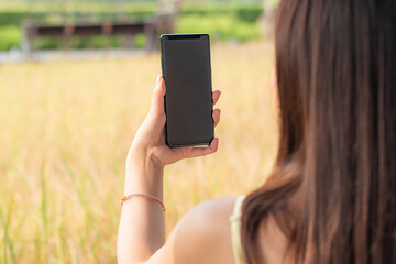 Close up of women hands holding cell smartphone with blank copy space scree for your advertising text message.